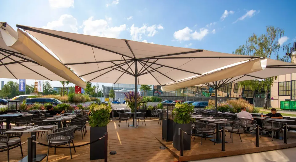 Großschirme mit verbindenden Regenrinnen über einer Restaurantterrasse